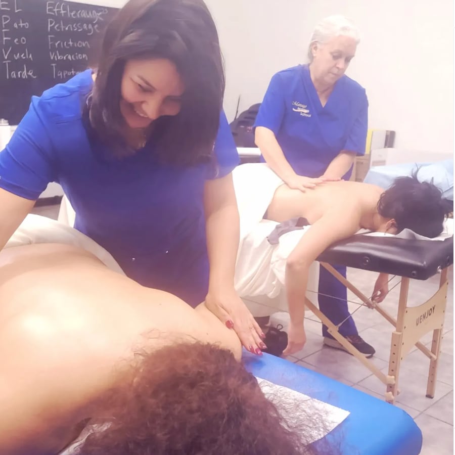 Students practicing massage techniques during class at Massage Masters School